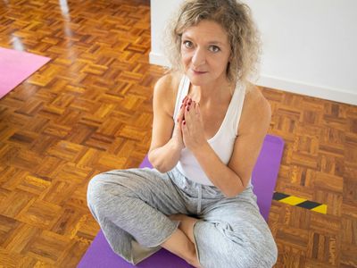 Woman practicing gentle yoga flow at home